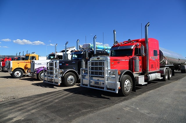 trucks lined up in truck stop parking lot