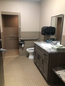 Waspy's trucker shower room with tile floor and toilet