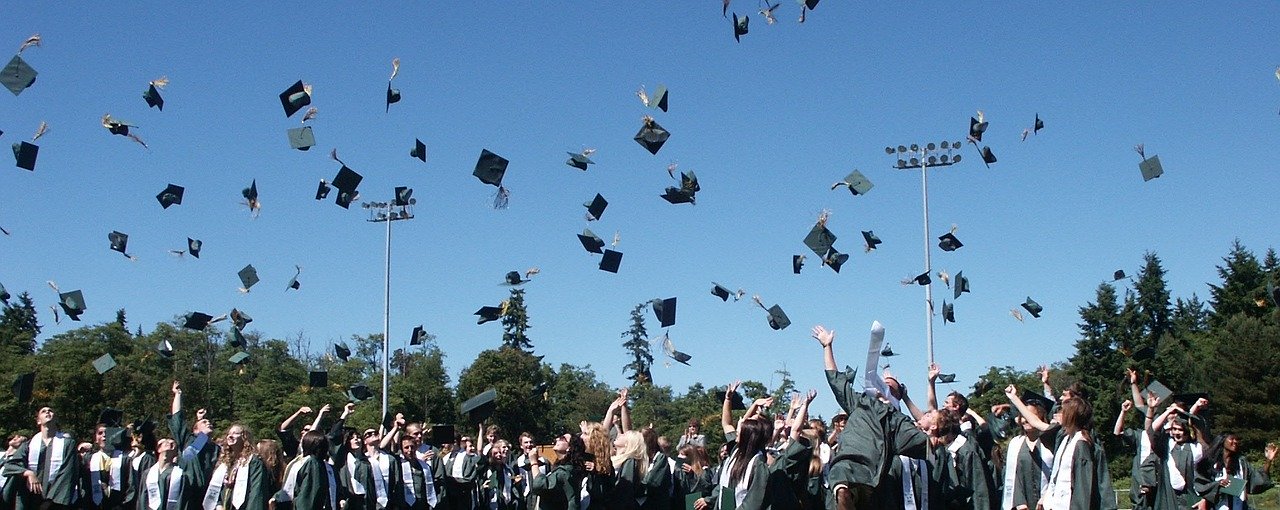 Graduates tossing caps